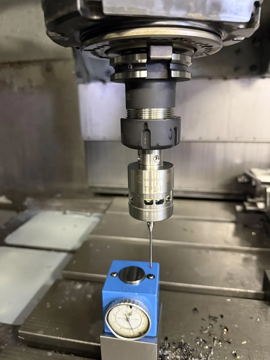 TP1-IR touch probe in a machining-centre spindle, its ruby stylus touching a tool setter